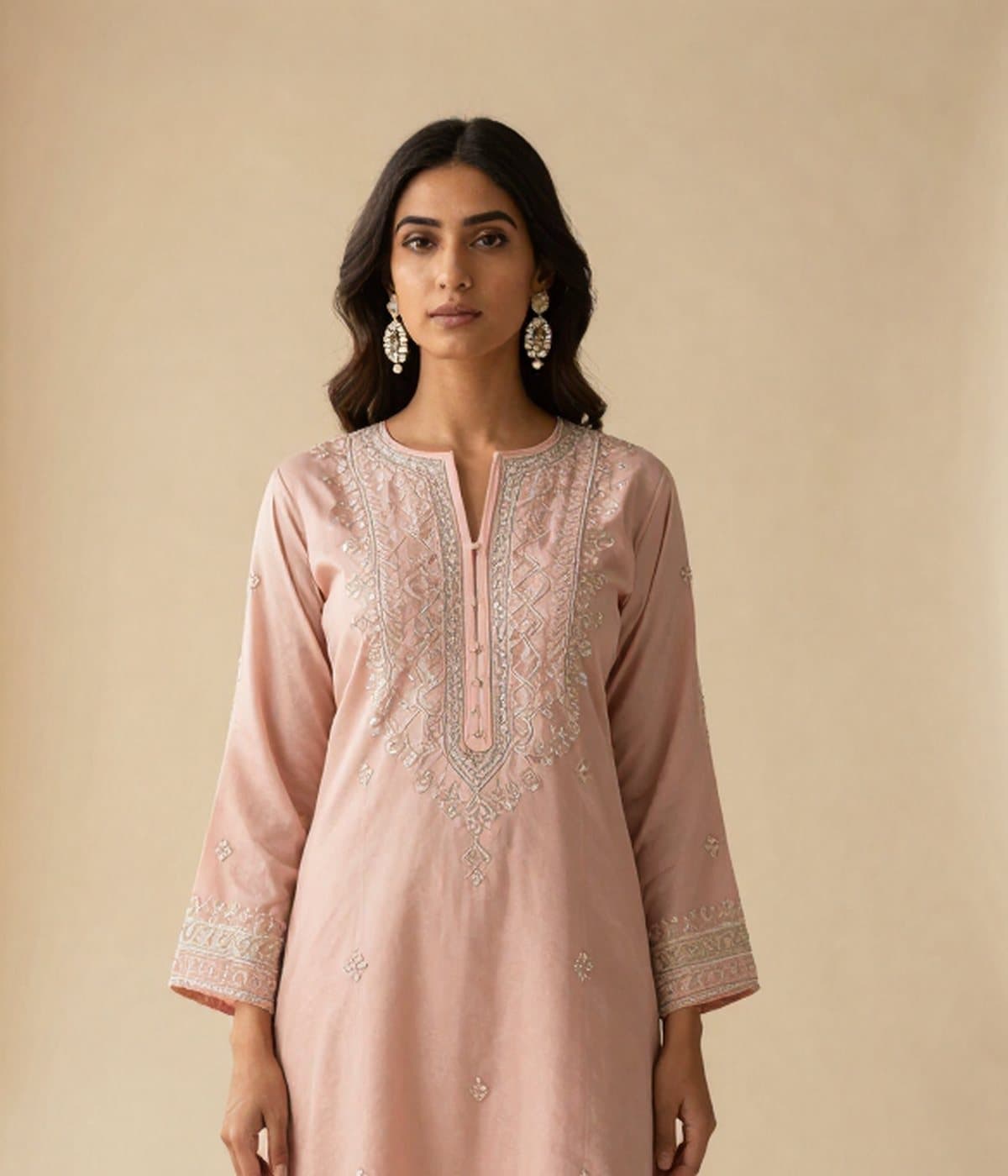 Embroidered placket and neckline of a blush kurta